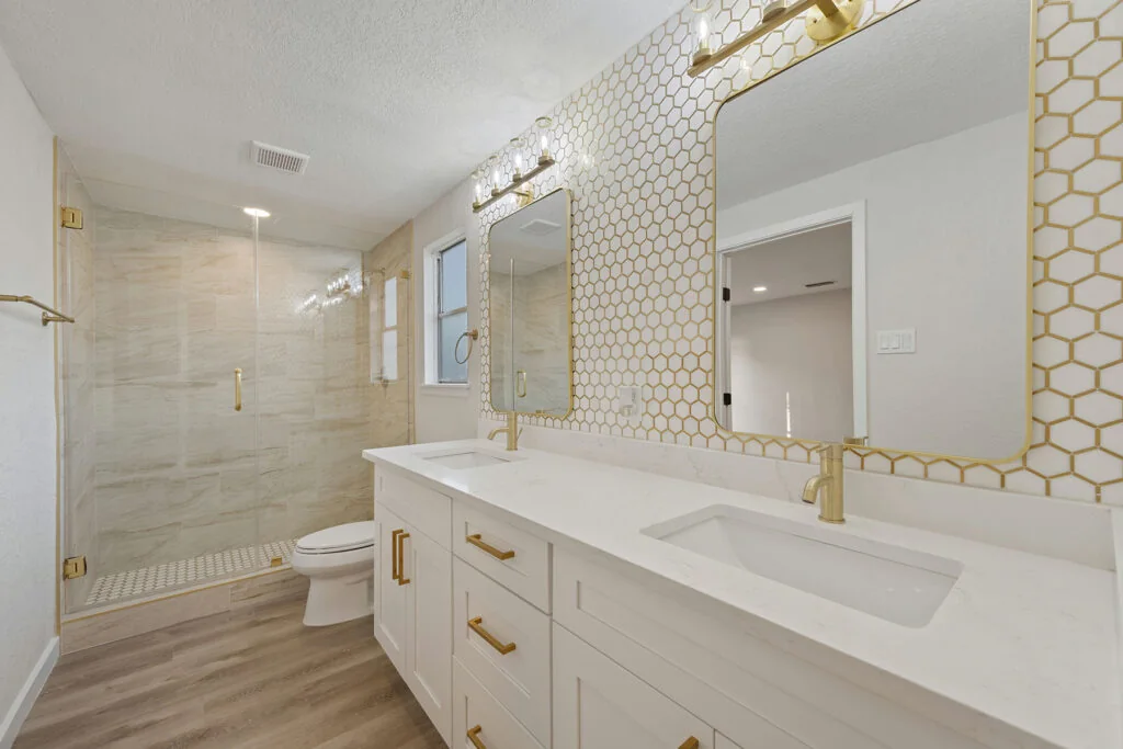 Finished bathroom with glass shower, vanity and tile