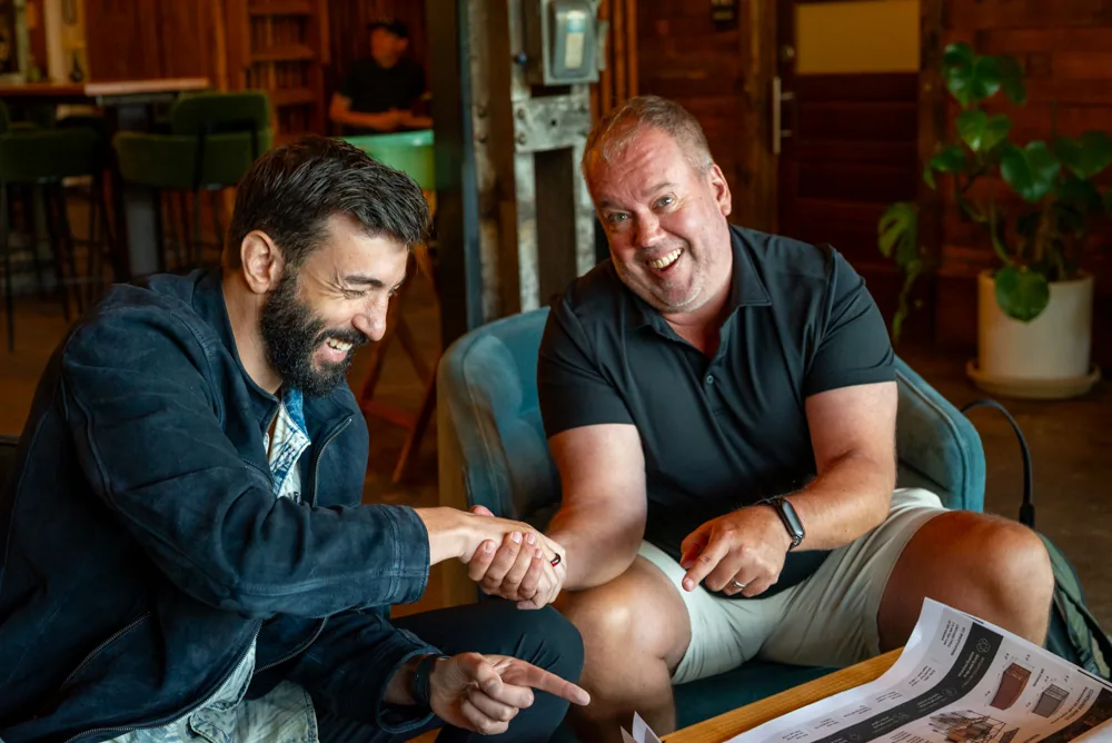 Brad Currin shaking hands over project plans